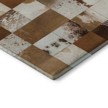 Close-up of the Dalyn Luxury Bozeman BM10 Brown Washable Area Rug. Features a patchwork design in brown, taupe, and cream hues.
