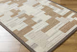 Close-up of the hand-tufted Berker Area Rug. Contemporary geometric design in beige, charcoal, cream, light gray, and taupe wool. Corner