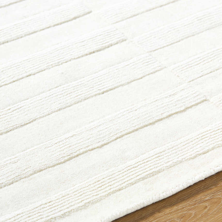 Close up of the cream Armina Area Rug showing its hand loomed texture and contemporary stripe design. Texture
