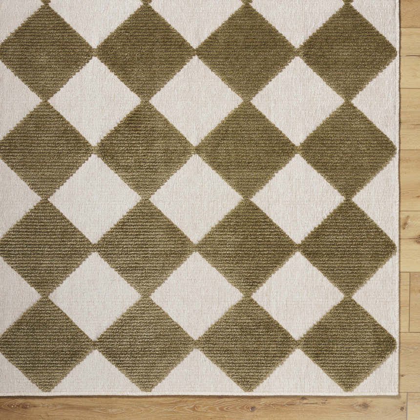 Close-up of Bosley Olive Washable Area Rug. Features a diamond pattern in olive green and off-white on a textured, machine-woven pile. Corner