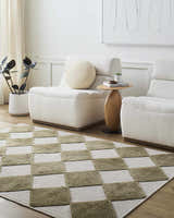 Living room scene with off-white chairs and Bosley Olive Washable Area Rug in a checkerboard pattern. Roomscene-Rectangle