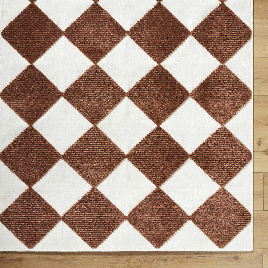 Close-up of the Bosley Brown Washable Area Rug. Features a brown and off-white diamond pattern with a textured weave. Corner