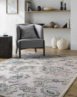 Coastal living room with a gray chair and the aqua and cream Benita Area Rug. Roomscene-Rectangle