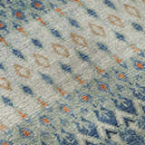 Close-up of Dalyn Brisbane BR1 Indigo Washable Area Rug. Features burnt, navy, teal, and taupe geometric design.