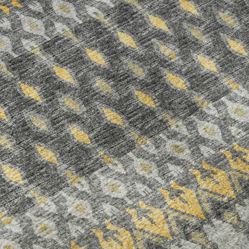 Close-up of Dalyn Brisbane BR1 Pewter Washable Area Rug. Gold, gray, and taupe casual rug with a geometric pattern.