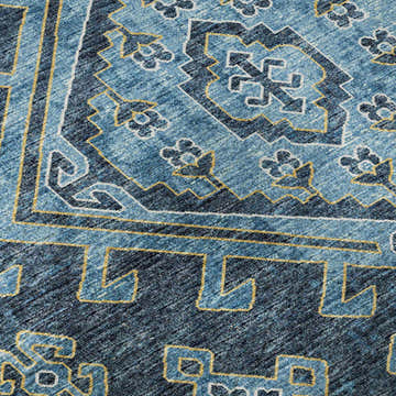 Close-up of the Dalyn Brisbane BR2 Navy Washable Area Rug. Features gold, navy, and sky blue geometric patterns.