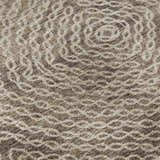 Close-up of the Dalyn Brisbane BR3 Mink Washable Area Rug, featuring a beige and brown circular pattern.