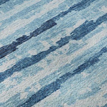 Close-up of Dalyn Brisbane BR4 Sky rug. Features a casual stripe pattern in sky blue, navy, and white. Machine-made texture.