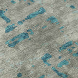 Close-up of Dalyn Brisbane BR5 Teal Washable Area Rug. Gray rug with abstract teal shapes and a textured, casual design.