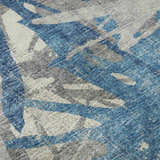 Close-up of Dalyn Brisbane BR6 Cobalt Washable Area Rug. Features a casual abstract pattern in blue, navy, taupe, and gray.