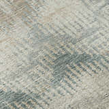 Close-up of Dalyn Brisbane BR9 Seascape washable area rug; beige, light brown, taupe, and teal casual design.