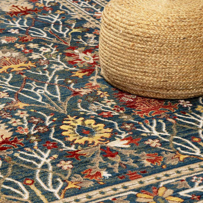 Close-up of the Livabliss Crafty CRT-2308 rug. Features a blue, red, and tan floral design with a traditional, farmhouse style. Styleshot