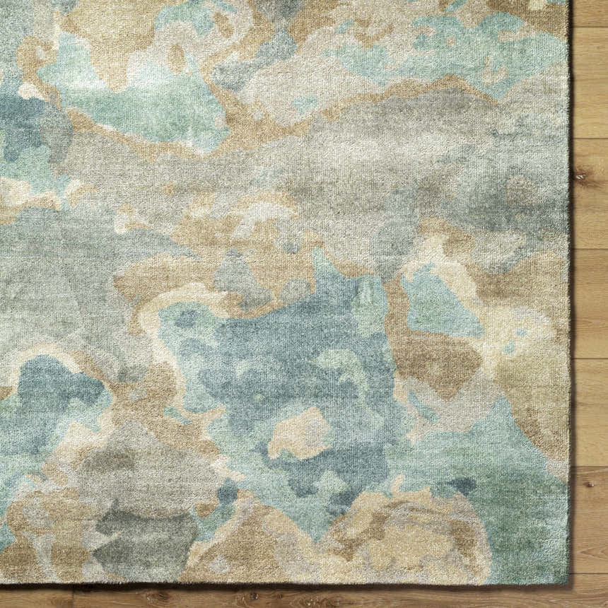 Close up of Briceville Premium Area Rug showing ivory, green, blue, peach, and wheat abstract pattern and wool texture. Swatch