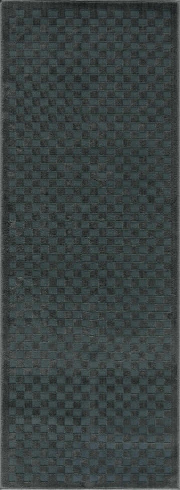 Close-up of the Gaiwan Oil Green Washable Area Rug. Features a textured checkerboard pattern in petrol blue and gray. Design-Runner