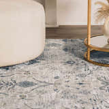Close-up of the Barkisland Thick Luxe Oushak Rug in light beige, teal, and gray with a floral pattern and a textured weave. Styleshot