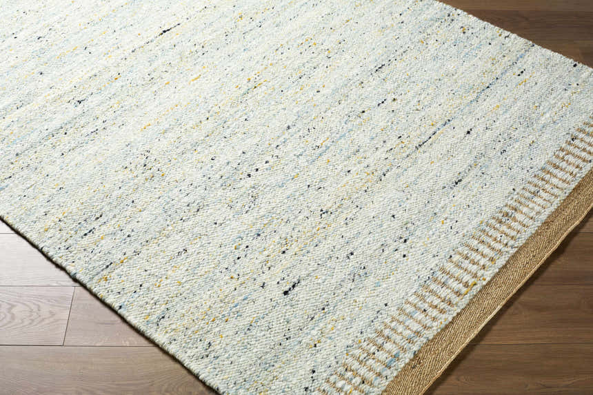 Close-up of the hand woven Andrey Dark Beige Area Rug, a contemporary wool rug with charcoal, light, and medium brown tones. Corner