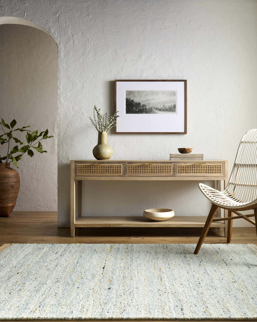 Entryway with light wood console table, woven chair, and Andrey Dark Beige Area Rug. Neutral, contemporary style. Roomscene-Rectangle
