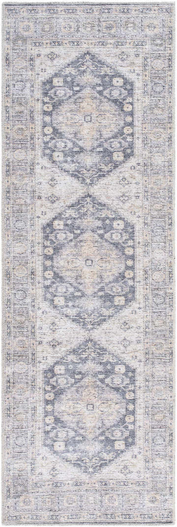 Close-up of the Bethan Washable Area Rug. Beige, navy, and off-white traditional rug with a farmhouse-style geometric pattern. Design-Runner-27710