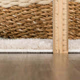 Close up of the Beynon Green Washable Area Rug showing the rug's edge, pile height, and construction. Pile