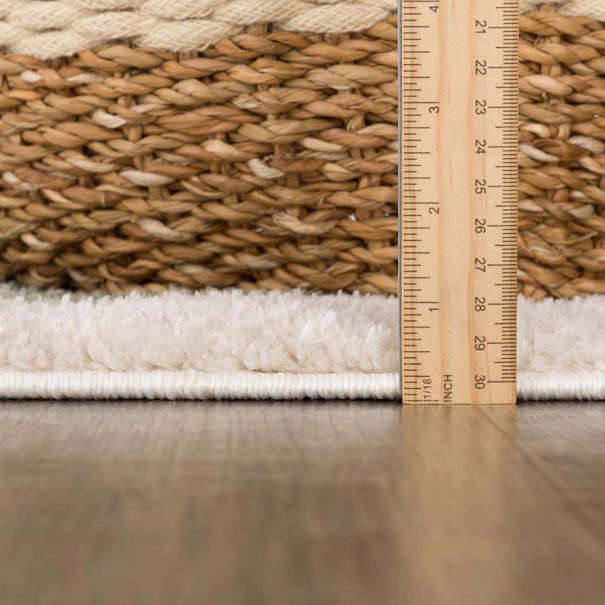 Close up of the Beynon Green Washable Area Rug showing the rug's edge, pile height, and construction. Pile