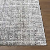 Close up of the Reyoa Light Gray rug showing its soft, textured pile and machine woven construction. Front