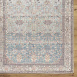 Close-up of the teal Bahram Vintage Flat Pile Washable Rug, featuring a traditional floral pattern and cream border. Corner