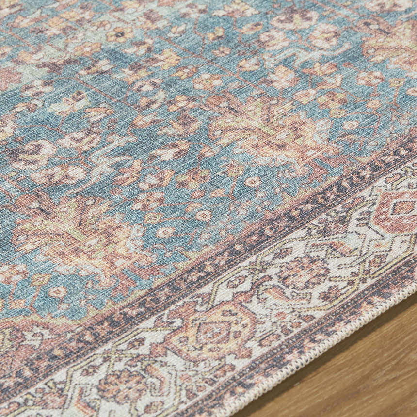 Close-up of Bahram Vintage Flat Pile Washable Rug; teal, cream, dark red, and orange traditional floral pattern. Texture