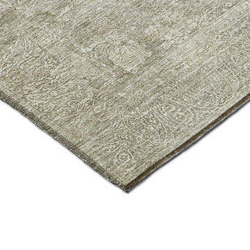 Close-up of the beige Dalyn Luxury Burano BU10 rug. The rug has a subtle, textured pattern and a chestnut-colored edge.