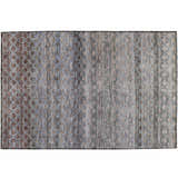 Close-up of a Dalyn Luxury Burano BU6 Brown Washable Area Rug. Features beige, brown, and blue tones with a subtle geometric pattern.