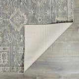 Close-up of the Collins Avenue I Vintage Oushak Area Rug showing its gray, beige, and brown tones and machine-woven texture. Fold