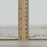 Close-up of the pile height of the Collins Avenue I Vintage Oushak Area Rug with a ruler. Pile