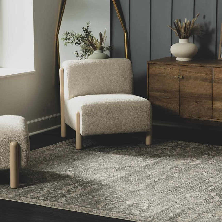 Living room scene with beige chair on a gray Collins Avenue I Vintage Oushak Area Rug. Roomscene-Rectangle