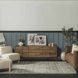 Living room scene with a beige Collins Avenue Vintage Oushak Area Rug, wood cabinet, and modern decor. Roomscene-Rectangle