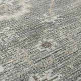 Close-up of the Collins Avenue I Vintage Oushak Area Rug. Soft texture with beige, gray, and dark brown vintage-style pattern. Texture