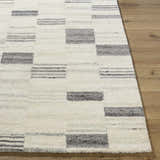 Close up of the Blaton Area Rug showing its ash, desert sand, and pearl colors and contemporary geometric design. Front