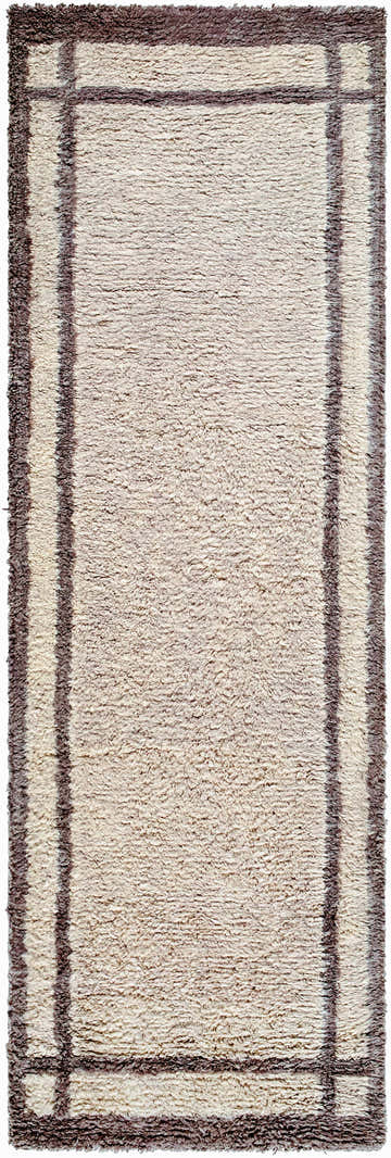 Close-up of the hand-tufted Aidric Area Rug. Features an ash-colored wool pile and a dark brown geometric border pattern. Design-Runner-268