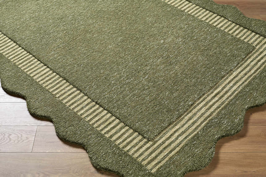 Close-up of a Wone Green Border Hand Tufted Wool Area Rug showing texture, striped border, and scalloped edge detail. Corner