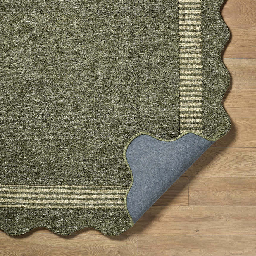 Close-up of Wone Green Border Hand Tufted Wool Area Rug showing texture, striped border, scalloped edge, and backing. Fold