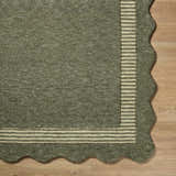 Close-up of Wone Green Border Hand Tufted Wool Area Rug showing texture, striped border, and scalloped edge. Corner