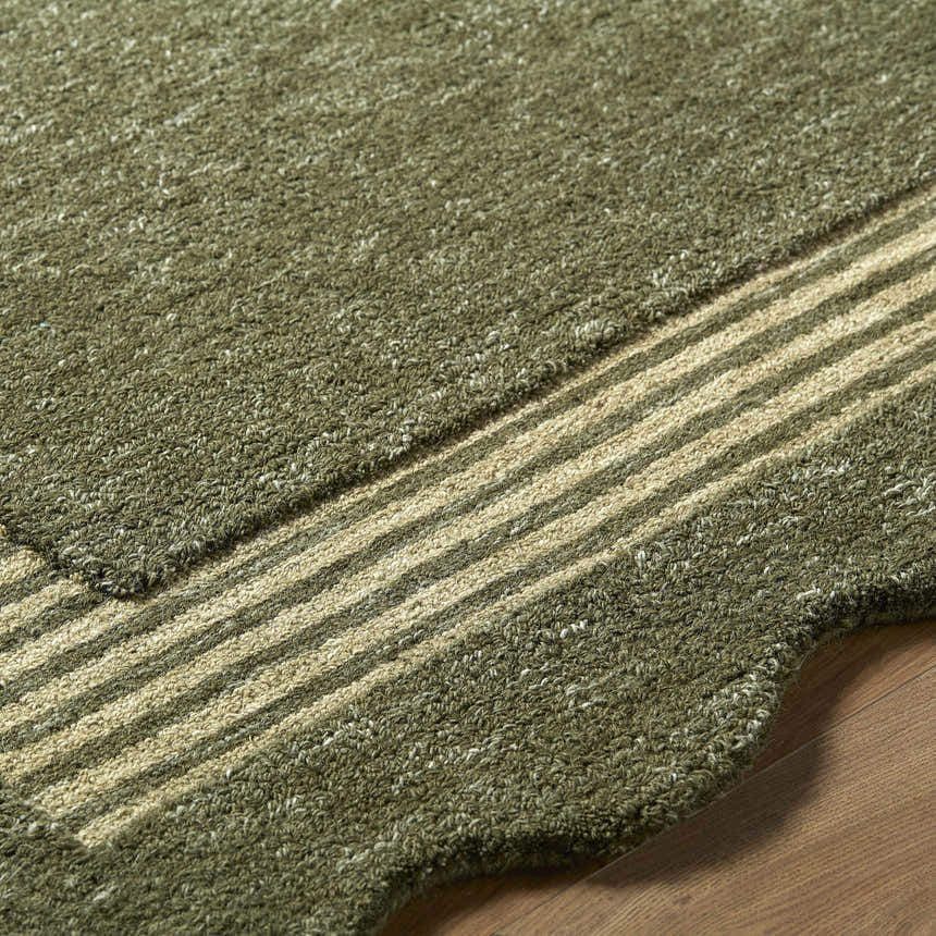 Close up of the hand tufted Wone Green Border Wool Rug showing texture and striped border detail. Texture