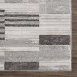 Close-up of Bronka Broken-Striped Area Rug. Geometric design in black, gray, and off-white. Machine woven texture. Swatch