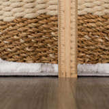 Close-up of Bronka Broken-Striped Area Rug showing rug thickness with a ruler. Colors are black, gray, and off white. Pile