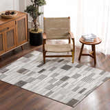 Living room scene with Bronka Broken-Striped Area Rug. Geometric rug in black, gray, and off-white complements wood furniture. Roomscene-Rectangle