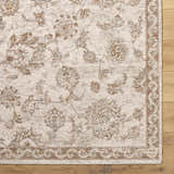 Close-up of the Chyron Cream Area Rug showing its floral pattern, light brown accents, and traditional border on a wood floor. Corner