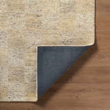 Close up of the hand tufted Chasya Sandstone Area Rug showing wool texture and backing. Colors: ivory, pebble, sandstone, taupe. Fold