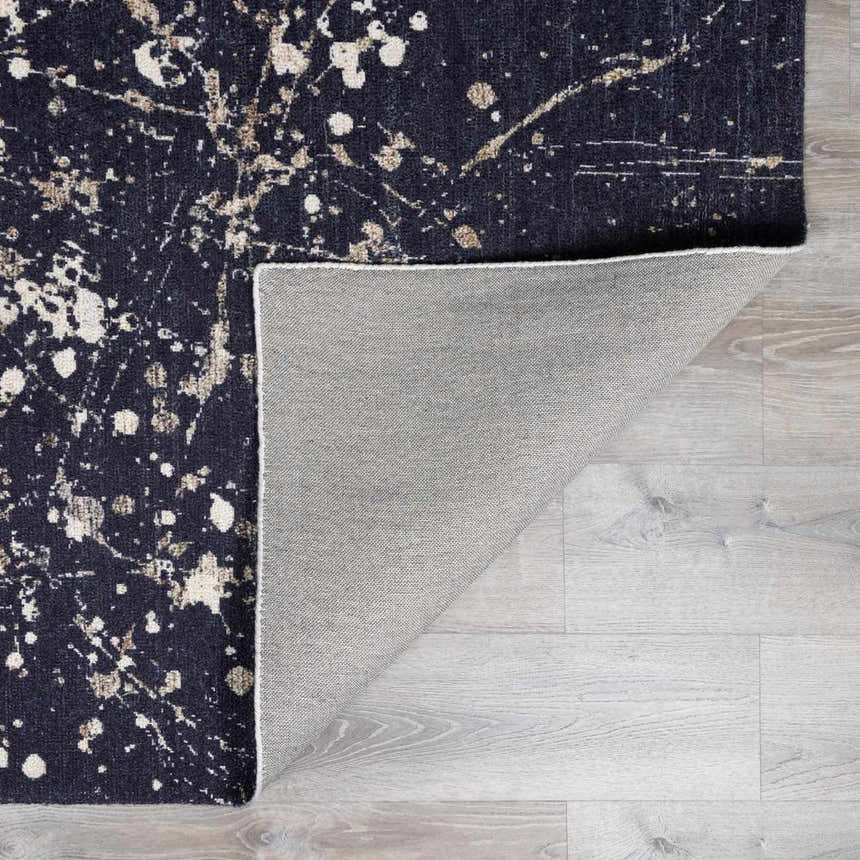 Close-up of Janek Handmade Galey Alix x LIVABLISS GAJA-2300 Area Rug. Charcoal rug with ivory and taupe splatter design. Fold