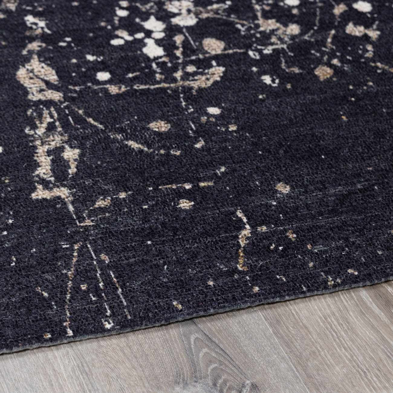 Close-up of Janek Handmade Galey Alix x LIVABLISS GAJA-2300 area rug. Charcoal rug with ivory and taupe abstract design. Pile