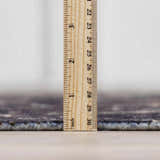 Close-up of the Janek Handmade Galey Alix x LIVABLISS GAJA-2300 rug pile height with a ruler showing the rug's thickness. Pile