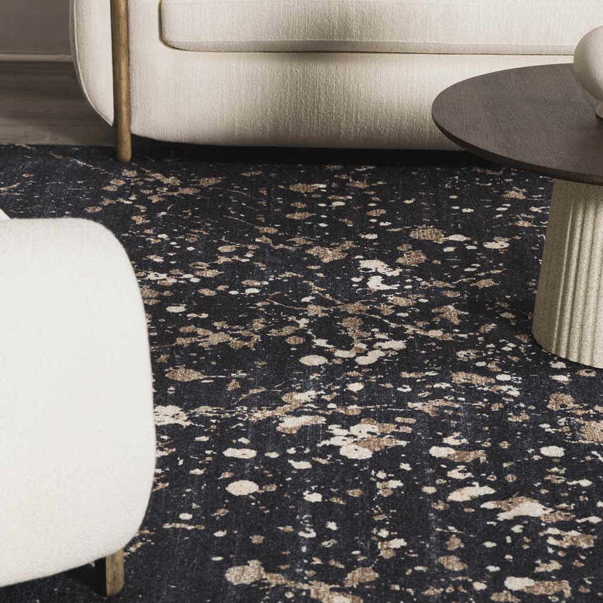 Close-up of the Janek Handmade Galey Alix x LIVABLISS GAJA-2300 Area Rug featuring a charcoal, ivory, and taupe splatter design. Styleshot