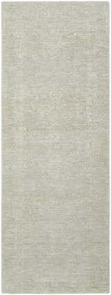 Close-up of the Catrin Area Rug, a machine-woven rug in light sage with a subtle traditional pattern. Design-Runner-273